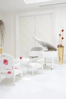 a white living room with two chairs and a couch at Boscolo Nice Hotel & Spa in Nice