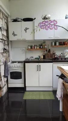 a kitchen with white cabinets and a stove at Lovely house in Cagnes-sur-Mer
