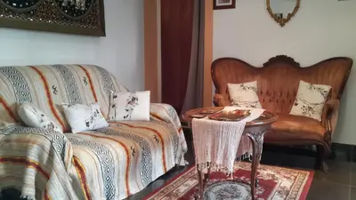 a living room with a couch and a table at Lovely house in Cagnes-sur-Mer