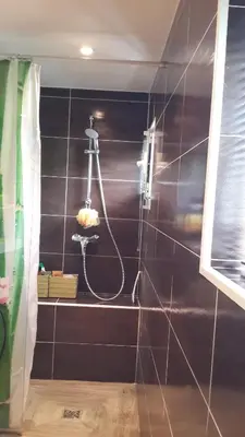 a bathroom with a black wall with a shower at Lovely house in Cagnes-sur-Mer