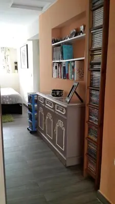 a kitchen with a stove in a room with dvds at Lovely house in Cagnes-sur-Mer