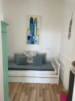 a white bed in a room with a picture on the wall at Hôtel La Villa Patricia - Charme et Tradition in Villefranche-sur-Mer