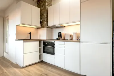 a white kitchen with white cabinets and appliances at 