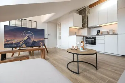 a living room with a table and a kitchen at 