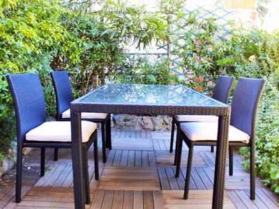 a glass table and chairs on a patio at Apartment Villa Anahit in Nice