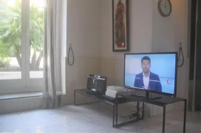 a television sitting on a table in a living room at Apartment Villa Anahit in Nice