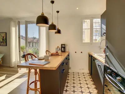 a kitchen with a counter and a table with chairs at Nestor&Jeeves - SUNNY TERRACE - Central - Very close sea - Top Floor in Nice