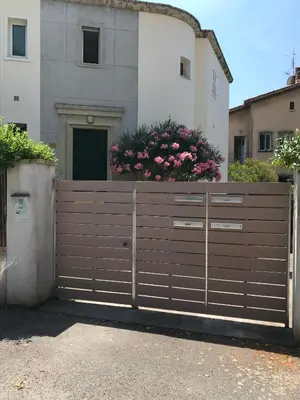 a wooden gate in front of a house at Au cœur de St Jean Cap Ferrat in Saint-Jean-Cap-Ferrat