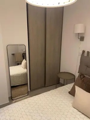 a bedroom with a mirror next to a bed at Au cœur de St Jean Cap Ferrat in Saint-Jean-Cap-Ferrat