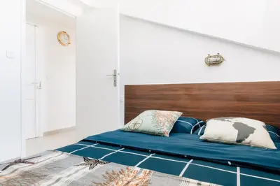 a bedroom with a large bed with a wooden headboard at Adorable apartment in Nice downtown in Nice