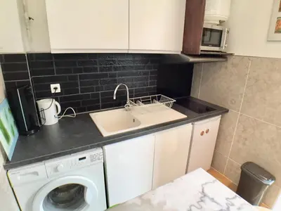 a kitchen with a sink and a washing machine at Niceaparts in Nice