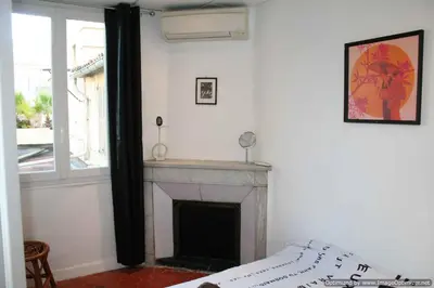 a bedroom with a fireplace and a window at Beach, Pure Centre, view over Opera de Nice in Nice