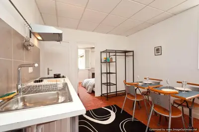 a kitchen with a sink and a table with chairs at Beach, Pure Centre, view over Opera de Nice in Nice