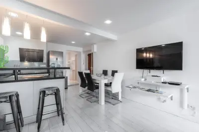 a kitchen and dining room with a table and chairs at Amazing 3 Bdrs and Garden Place du Pin Parking ! in Nice