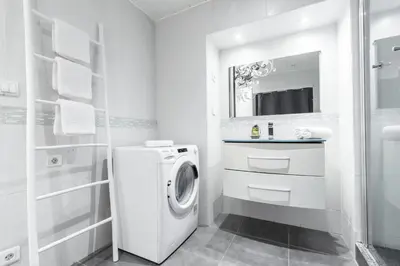a white bathroom with a washing machine and a sink at Amazing 3 Bdrs and Garden Place du Pin Parking ! in Nice