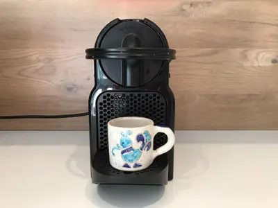 a black coffee maker with a cup in it at Sunny apartment in heart of Nice Old Town in Nice