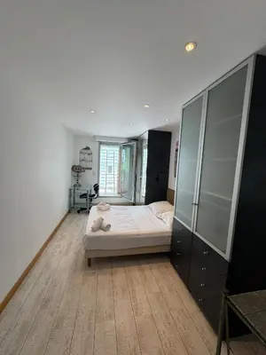 a bedroom with a bed and a glass cabinet at SIENA - Appartement 6 personnes avec Terrasse et Jacuzzi plein cœur centre-ville quartier du Port de Nice in Nice