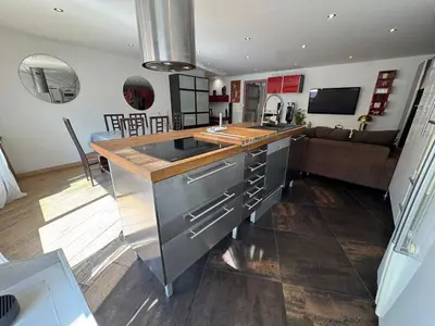 a kitchen with a counter and a living room at SIENA - Appartement 6 personnes avec Terrasse et Jacuzzi plein cœur centre-ville quartier du Port de Nice in Nice