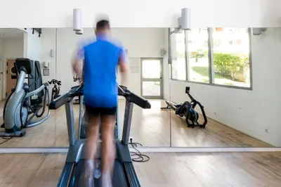 a man on a treadmill in a gym at Nemea Appart Hotel Le Lido Cagnes sur Mer in Cagnes-sur-Mer