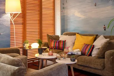 a living room with a couch and two tables at Hotel Beau Rivage in Nice