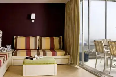 a living room with a couch and a table and chairs at Appt 5 personnes vue mer piscine Costa Plana Cap d'Ail Monaco in Cap d'Ail