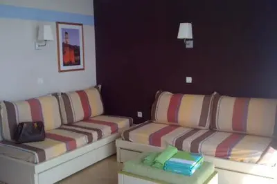 a living room with two couches and a table at Appt 5 personnes vue mer piscine Costa Plana Cap d'Ail Monaco in Cap d'Ail