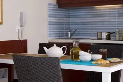 a kitchen with a table with a tea set on it at Appt 5 personnes vue mer piscine Costa Plana Cap d'Ail Monaco in Cap d'Ail
