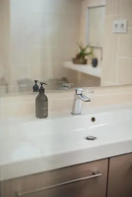 a bathroom sink with a soap dispenser on it at 