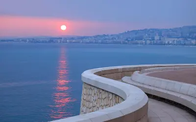 a sunset over a large body of water at 