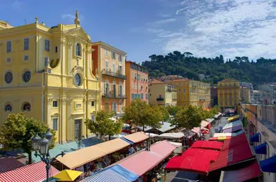 a city street with tables and umbrellas and buildings at 