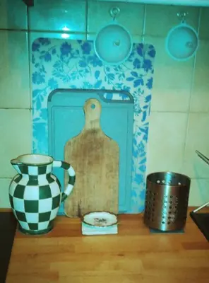 a table with a jug and a vase on it at Chez Brigitte Guesthouse in Nice
