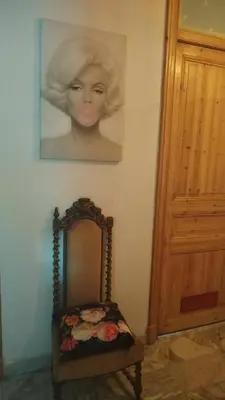a picture of a woman on the wall next to a mirror at Chez Brigitte Guesthouse in Nice