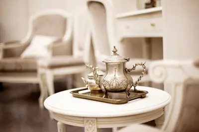 a tea pot on a table in a living room at Hôtel restaurant Oasis in Nice