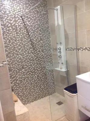 a shower with a glass door in a bathroom at La Lanterne Plage in Nice