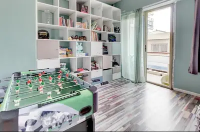 a room with a book shelf and a window at La Lanterne Plage in Nice