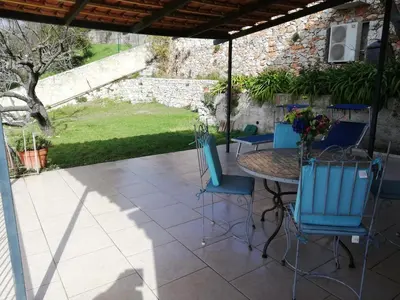 a living room with chairs and a table with a balcony at Villa Mt Fleuri in Nice