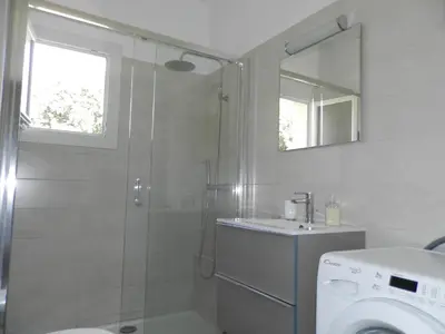 a bathroom with a shower and a washing machine at Les Pins . 2 p calme et terrasse in Nice