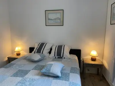 a bedroom with a bed and two lamps on tables at O Phare du Cros in Cagnes-sur-Mer