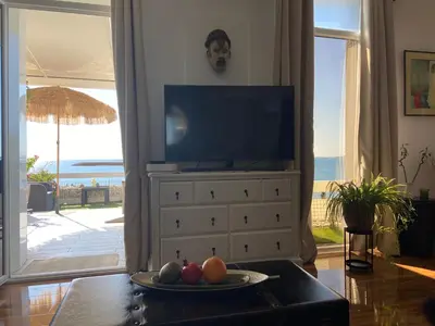 a living room with a television on a dresser at O Phare du Cros in Cagnes-sur-Mer