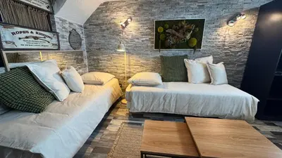 a hotel room with two beds and a couch at O Phare du Cros in Cagnes-sur-Mer