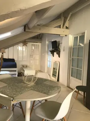 a dining room with a table and chairs at Les Citronniers in Villefranche-sur-Mer