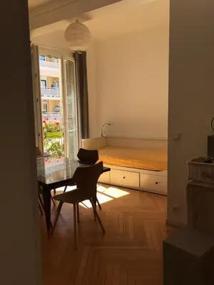 a bedroom with a bed and a table and a desk at Nissa la Bella in Nice
