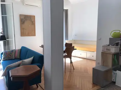 a living room with a blue couch and a table at Nissa la Bella in Nice