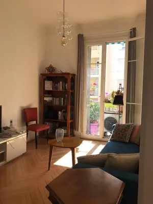 a living room with a blue couch and a table at Nissa la Bella in Nice