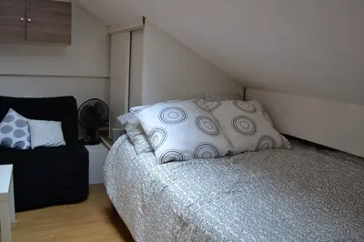 a bedroom with a bed with pillows on it at Aoustin in Nice