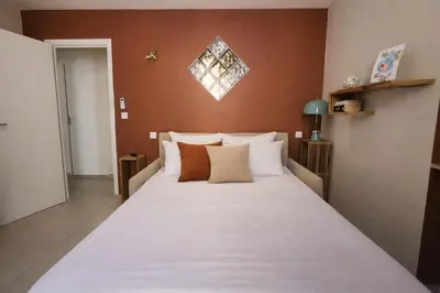 a bedroom with a large bed with white sheets at Promenade Appartements les Lions in Nice