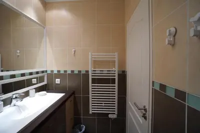 a kitchen with stainless steel appliances and black cabinets at Apartment with parking in Nice near the harbor in Nice