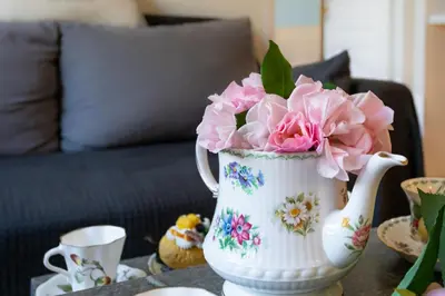 a vase with pink flowers in it on a table at Boutique apartment LA LAVANDE free parking CENTER Nice in Nice