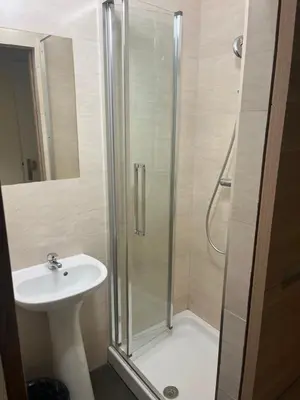 a bathroom with a shower and a sink at Hôtel Lyonnais in Nice