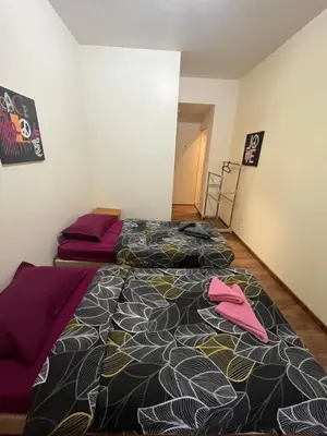 a bedroom with two beds in a room at Hôtel Lyonnais in Nice